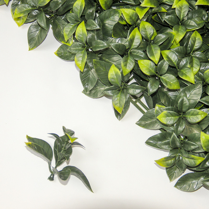 La nueva vertical modificada para requisitos particulares del estilo de la selva planta la hierba verde de la planta artificial del tapiz para la decoración casera